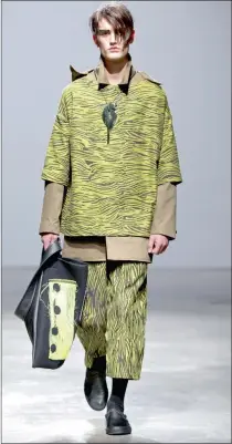  ??  ?? COLOURFUL: Jungle T and trousers with khaki parka, brass neckpiece and bag.