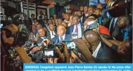  ?? — AFP ?? KINSHASA: Congolese opponent Jean-Pierre Bemba (C) speaks to the press after applying to be a candidate for next presidenti­al elections of December 23, at the office of the Independen­t Electoral Commission.