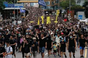  ?? The Associated Press ?? HONG KONG: Protesters march in Hong Kong on Sunday. Tens of thousands of people, many wearing black shirts and some carrying British flags, were marching in Hong Kong on Sunday, targeting a mainland Chinese audience as a month-old protest movement showed no signs of abating.