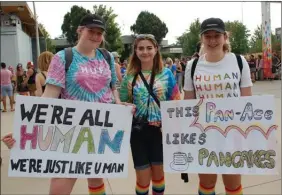  ?? ANDREA PEACOCK/The Daily Courier ?? Scotia Fullerton-Collison, Nicole Matthews and Rachel Pickard brought these signs to the 10th annual Okanagan Pride March on Saturday.