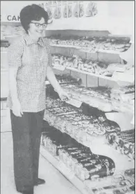  ?? ?? Billie Law arranges the fresh delivery of bakery goods in the relocated Eddy’s Bakery Thrift Store. As of Thursday, the store is now operating from 127 Second Ave. SE in Valley City.