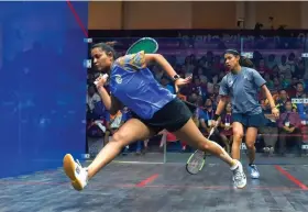  ?? — PTI ?? Deepika Pallikal ( left) of India and Nicol Ann David of Malaysia in action during the women’s squash semifinal in Jakarta on Saturday.