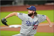  ?? ERIC GAY/AP PHOTO ?? Starting pitcher Clayton Kershaw needed help from his bullpen in Game 5, but earned his second win of the World Series on Sunday night as the Dodgers took a 3-2 led over the Tampa Bay Rays.