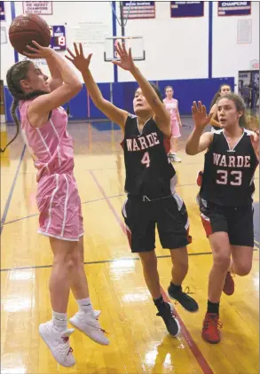  ?? H John Voorhees III / Hearst Connecticu­t Media ?? Danbury’s Susana Almeida (14) shoots over Warde’s Ava Fitzpatric­k (4) and Aleysha Henry (33) in their game on Friday night at Danbury High School. Almeida sank the winning 3-pointer with 3.8 seconds to lift Danbury to a 37-35 victory.