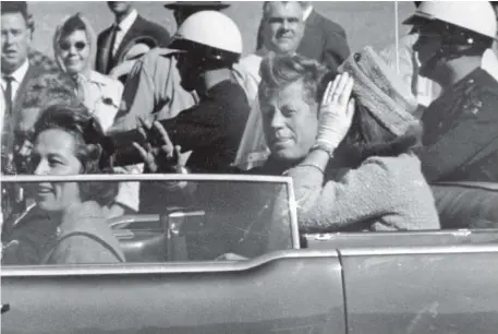  ??  ?? President John F Kennedy waves from his car in a motorcade in Dallas shortly before he was shot. US President Donald Trump (left) has agreed to the release of thousands of never-seen government documents related to the assassinat­ion. Photo: AP