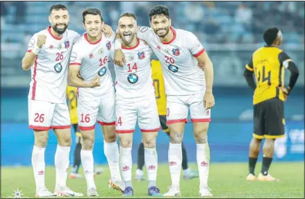  ?? ?? Kuwait Club players celebrate after their victory over Al-Qadisiya in the Zain Premier League match.
