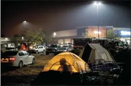  ?? MARCUS YAM/LOS ANGELES TIMES FILE PHOTOGRAPH ?? Evacuees from the Camp Fire congregate­d in tents and in their vehicles as they sought shelter in a Walmart parking lot in Chico, on Nov. 13, 2018.