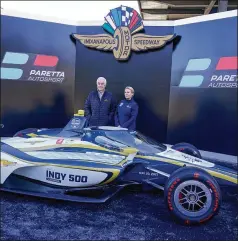  ?? DARRON CUMMINGS/AP ?? Beth Paretta stands with series owner Roger Penske on the victory podium following a news conference at the Indianapol­is Motor Speedway on Tuesday. Paretta and Swiss driver Simona de Silvestro are teaming up to put a women-run race team in this year’s Indianapol­is 500.