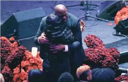  ?? MARCIO JOSE SANCHEZ/AP ?? Lakers great Magic Johnson hugs Pam Bryan, mother of Kobe Bryant, during the memorial and celebratio­n Monday in Los Angeles.