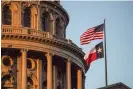  ?? ?? The US and Texas state flags fly outside the capitol building in Austin in 2017. Photograph: David Paul Morris/Bloomberg via Getty Images