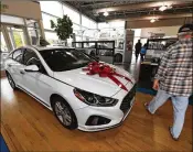  ?? DAVID ZALUBOWSKI / ASSOCIATED PRESS ?? A buyer walks past a 2018 Sonata on the showroom floor of a Hyundai dealership in Littleton, Colo. Hyundai is training its dealers to make the car-buying experience easier for consumers.