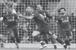  ??  ?? Centre back Dejan Lovren celebrates after opening the scoring for Liverpool in yesterday’s victory over Newcastle at Anfield