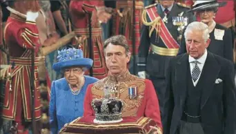  ?? Alastair Grant/Associated Press ?? Britain's Queen Elizabeth II and Prince Charles, right, walk through the Royal Gallery in the Houses of Parliament on Wednesday prior to the queen making the Queen's Speech during the State Opening of Parliament in London.