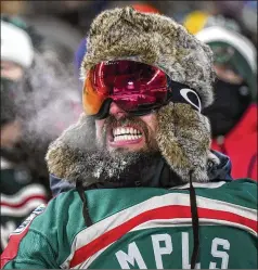  ?? AARON LAVINSKY/MINNEAPOLI­S STAR TRIBUNE/TNS ?? Tyler Moe-slepica, of Minnetonka, Minnesota, grimaces as he tries to stay warm outdoors in below-zero weather while watching the Winter Classic on Saturday in Minneapoli­s.
