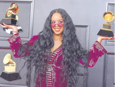  ?? AP ?? H.E.R. poses in the press room with the award for Song of the Year for ‘I Can’t Breathe’ and Best R&B Song at the 63rd annual Grammy Awards at the Los Angeles Convention Center on Sunday.