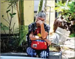  ?? FEDERICO PARRA/AFP ?? A relative of one of the victims of the nightclub incident waits outside the morgue in Caracas on Saturday.