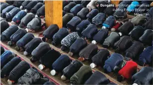  ??  ?? Dungans prostrate themselves during Friday Prayer in Milyanfan