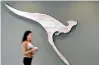  ??  ?? A woman walks past the logo of Australia’s national air carrier Qantas at the company’s head office in Sydney