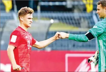  ?? POOL/AFP ?? Bayern Munich’s German midfielder Joshua Kimmich (left) scored the match’s only goal against Borussia Dortmund.