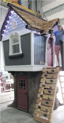  ?? THE CANADIAN PRESS ?? Charmed Playhouses founder Tyson Leavitt stands on the porch of one of his luxury playhouses in his workshop in Lethbridge, Alta.