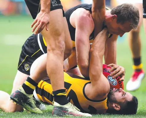  ?? Picture: GETTY ?? ANGER: Hawk Paul Puopolo and Dylan Grimes, of the Tigers, clash yesterday over a high-tackle free kick.