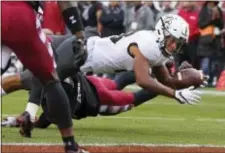  ?? RICH SCHULTZ — THE ASSOCIATED PRESS ?? Central Florida’s Gabriel Davis reaches for the goal line and scores a touchdown after being hit by Temple’s Linwood Crump during the second quarter Saturday.