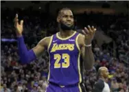  ?? CHRIS SZAGOLA — THE ASSOCIATED PRESS ?? The Lakers’ LeBron James reacts during the second half against the 76ers, Sunday in Philadelph­ia. The 76ers won 143-120.