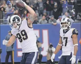  ?? Bill Kostroun Associated Press ?? TYLER HIGBEE, left, celebratin­g in front of receiver Robert Woods after scoring a touchdown last season, is among the tight ends the Rams are counting on.