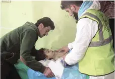  ?? — AFP ?? This file photo taken on April 04, 2017 shows an unconsciou­s Syrian child receiving treatment at a hospital in Khan Sheikhun, a rebel-held town in the northweste­rn Syrian Idlib province, following a suspected toxic gas attack.