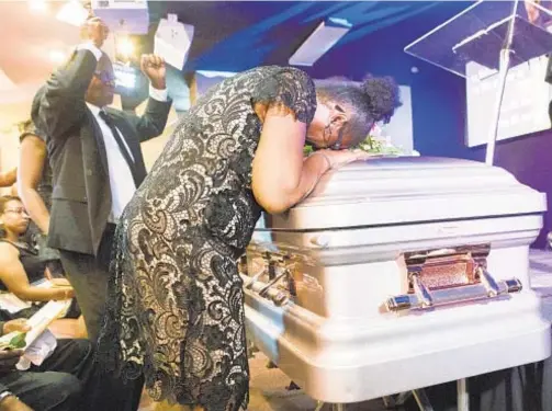  ?? ALEX RUD ?? Claudette Edwards weeps over her daughter Shaena Sinclair's coffin during funeral services at the Purpose Life Church on Flatlands Ave. in Brooklyn on Saturday. The mom seen with her 6-year-old son, Jayvon Williams (below) .