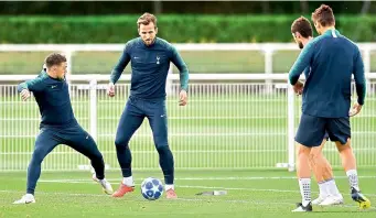  ?? AFP ?? Tottenham Hotspur players Kieran Trippier (left) and forward Harry Kane (second from left) take part in their training session at Enfield Training Centre, north London, on Tuesday, eve of their UEFA Champions League Group ‘B’ match against Barcelona. —