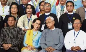  ??  ?? Big day: Suu Kyi (seated, second from left) during a photo session following the peace talks at the Myanmar Internatio­nal Convention Centre. — AP