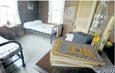  ??  ?? Elementary school books sit on a chest in a bedroom of a home where singer Johnny Cash spent much of his childhood in Dyess, Ark. The Arkansas Historic Preservati­on Program’s review board is to meet Wednesday, to consider 14 state properties for...