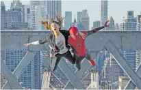  ?? MATT KENNEDY/SONY PICTURES/TNS ?? MJ (Zendaya) and Spider-Man (Tom Holland) jump off a bridge in “Spider-Man: No Way Home.”