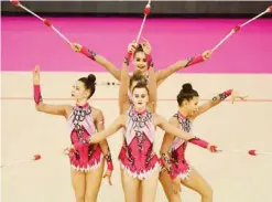  ?? —AFP ?? BUDAPEST: Austrian team perform with their clubs during the 33rd Rhythmic Gymnastics European championsh­ips.