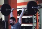  ?? ANGELA PETERSON / MILWAUKEE JOURNAL SENTINEL ?? Josh Zuback, 31, does a push press exercise at Brew City Cross Fit.