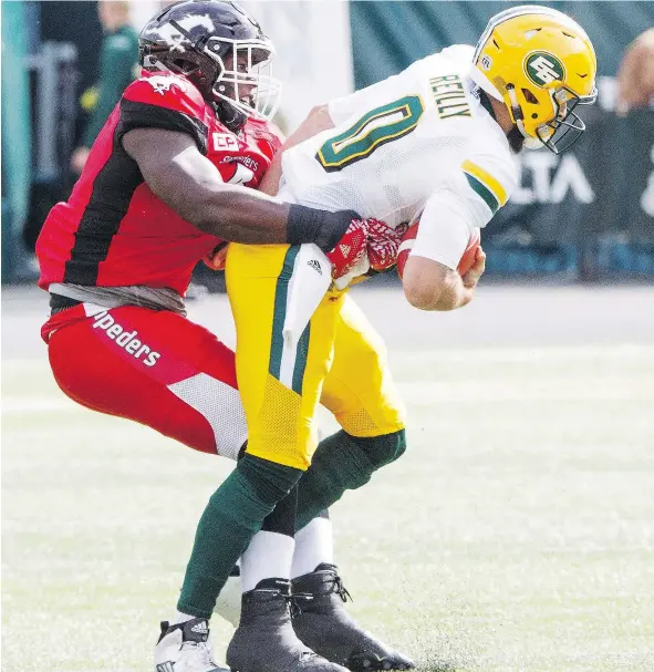  ?? — THE CANADIAN PRESS FILES ?? With their defensive line ravaged by injuries, the Calgary Stampeders have had to lean on Micah Johnson, left.