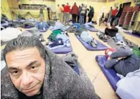  ?? SUN SENTINEL FILE ?? People get ready to sleep at Broward Outreach Center in Hollywood in December 2010. Broward County has approved new ID cards to help make it easier for the homeless and illegal immigrants to gain access to public services.