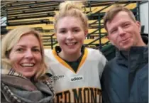  ?? PHOTO BY PAUL POST ?? Lilly Holmes celebrated her team’s victory over Merrimack with her parents Barbara and Robert, on Saturday.