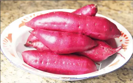  ?? ?? Purple-flesh sweet potatoes scrubbed and ready for cooking (Photo by Cynthia Nelson)