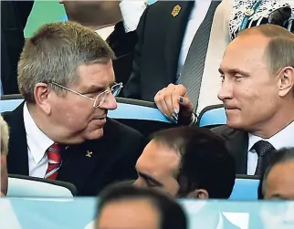  ??  ?? Internatio­nal Olympic Committee President Thomas Bach (left) talks with Russia’s President Vladimir Putin.