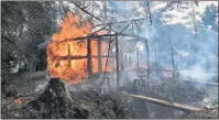  ?? AP PHOTO ?? Houses are on fire in Gawdu Zara village, northern Rakhine state, Myanmar, Thursday. Journalist­s saw new fires burning Thursday in the Myanmar village that had been abandoned by Rohingya Muslims, and where pages from Islamic texts were seen ripped and...