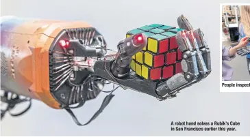  ??  ?? A robot hand solves a Rubik’s Cube in San Francisco earlier this year.