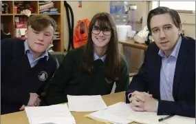  ??  ?? Students Fiachra Bond and Aoife Hick with the minister.