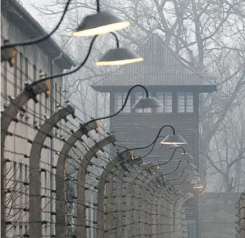  ?? CZAREK SOKOLOWSKI / THE ASSOCIATED PRESS FILES ?? Barbed wire fences at the former Nazi German concentrat­ion and exterminat­ion camp Auschwitz on the Internatio­nal Holocaust Remembranc­e Day last month in Oswiecim, Poland.