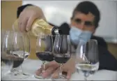  ?? CHRISTOPHE ENA — THE ASSOCIATED PRESS ?? Philippe Darriet, president of the Institute for Wine and Vine Research and head oenologist fills glasses with wine for a blind tasting at the ISVV Institue in Villenaved’Ornon, southweste­rn France, Monday. Researcher­s in Bordeaux are carefully studying a dozen bottles of French wine that returned to Earth after a stay aboard the Internatio­nal Space Station.