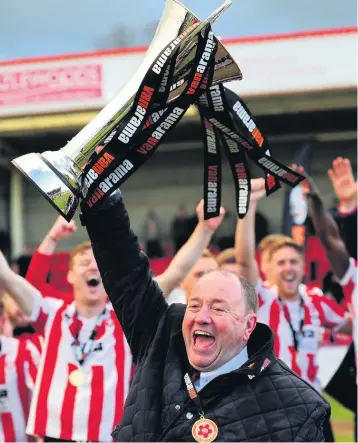  ??  ?? Gary Johnson celebrates after Cheltenham Town were crowned Vanarama National League champions in April 2016