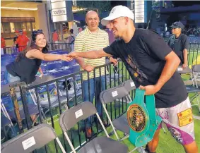  ?? STEWART F. HOUSE/THE DALLAS MORNING NEWS VIA AP ?? Fidel Maldonado Jr. greets fans with his WBC Fecarbox Super Lightweigh­t championsh­ip belt after his win over Pablo Cesar Cano on Saturday night.