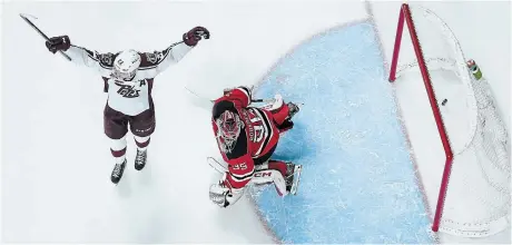  ?? DARRYL DYCK THE CANADIAN PRESS ?? Peterborou­gh Petes centre Tucker Robertson celebrates teammate Avery Hayes’s goal against Quebec Remparts goalie William Rousseau in Kamloops, B.C., on Tuesday.