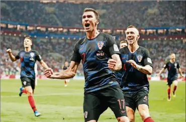  ?? FRANK AUGSTEIN/THE ASSOCIATED PRESS ?? Croatia’s Mario Mandzukic celebrates after scoring his side’s second goal during the semifinal match against England at the World Cup in the Luzhniki Stadium on Wednesday in Moscow.